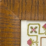 corner of framed crosstitch