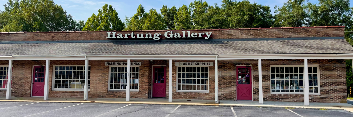 Hartung Gallery storefront, long brick building, red doors