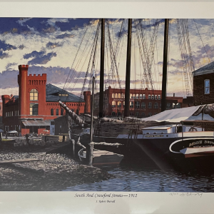 historical brick buildings and dock with masted ship
