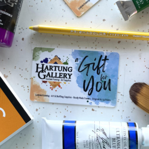 image of gift card surrounded by art supplies